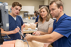 Nurse anesthesia students and instructor in a simulation lab