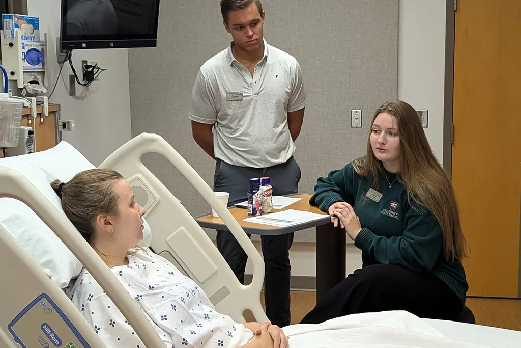 students and patient in exam room