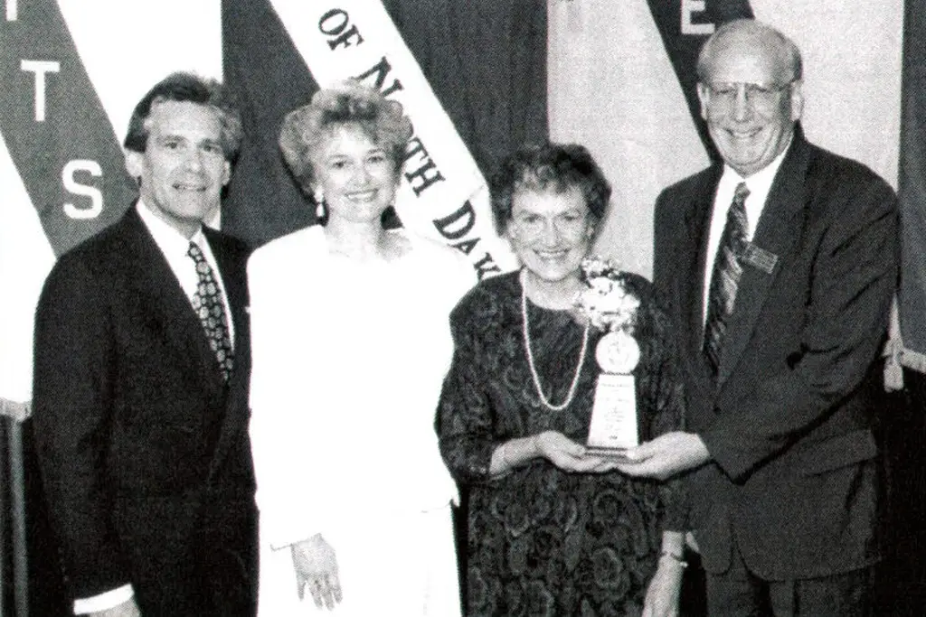 Kendall Baker, Toby Baker, Burness Wenberg (holding trophy), Earl Strinden