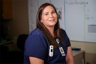 Amy Joshua in her blue scrubs at the clinic