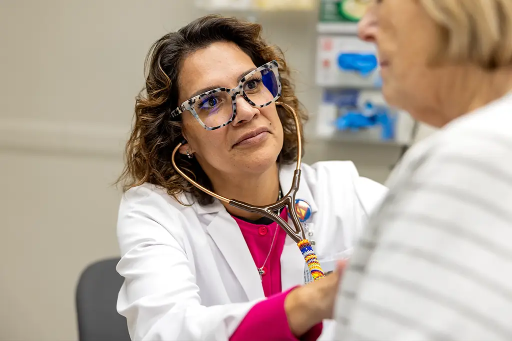 A nurse examines a patient